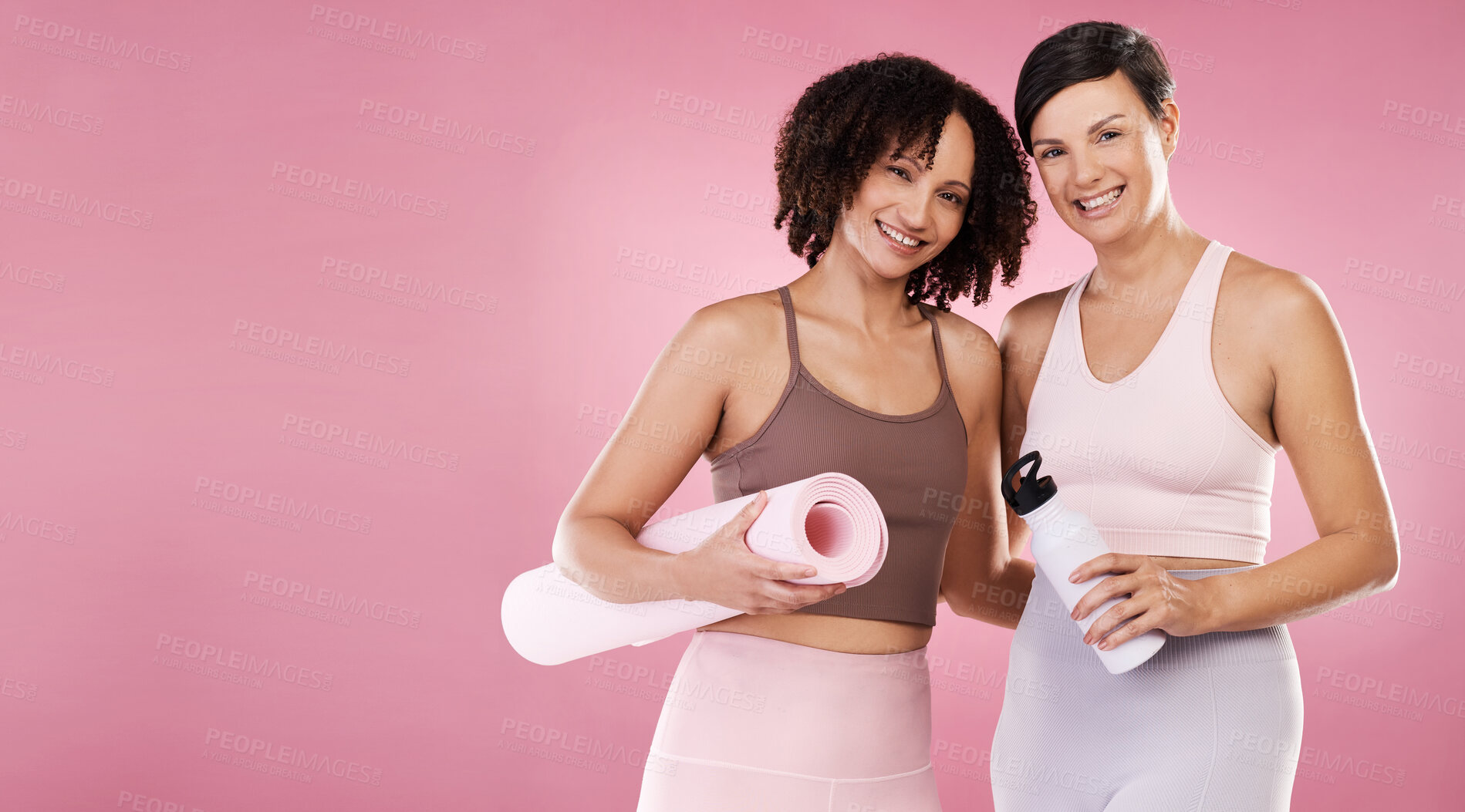 Buy stock photo Cropped portrait of two attractive young female athletes posing in studio against a pink background