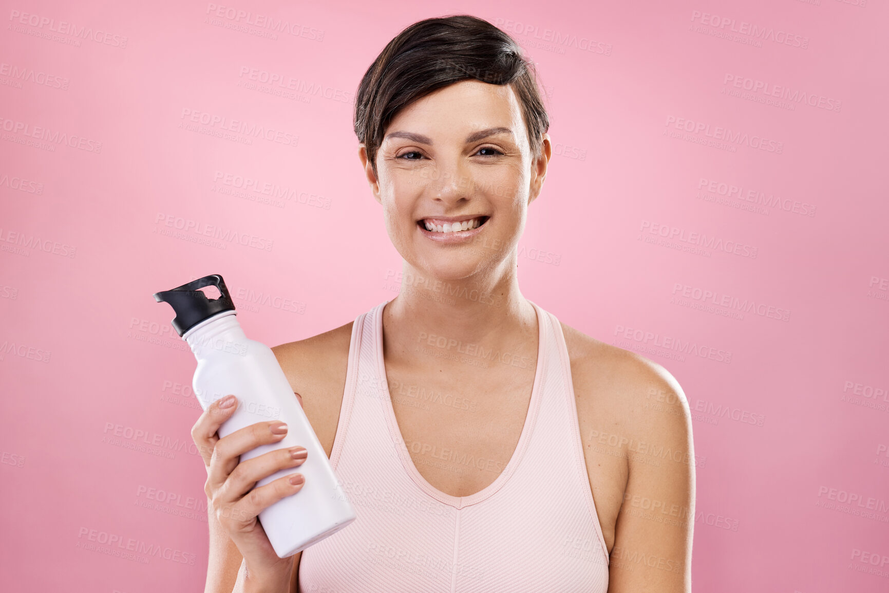Buy stock photo Cropped portrait of an attractive young female athlete posing in studio against a pink background