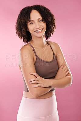 Buy stock photo Cropped portrait of an attractive young female athlete standing with her arms folded in studio against a pink background