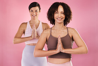 Buy stock photo Cropped portrait of two attractive young female athletes meditating in studio against a pink background