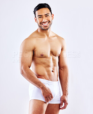 Buy stock photo Fitness, man and happy in underwear on studio, white background or bodybuilder portrait in mockup. Healthy, athlete and model with abs, arms or muscle from exercise and progress from workout at gym