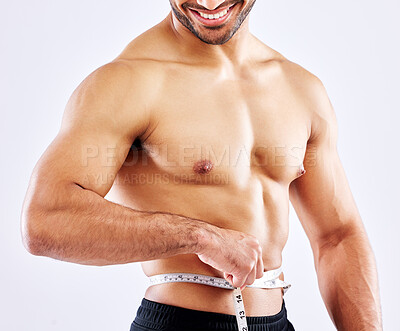 Buy stock photo Man, healthy and measuring tape for results as bodybuilder in competition, strength and wellness in studio. Fitness, male person and muscle for diet, workout and exercise in white background