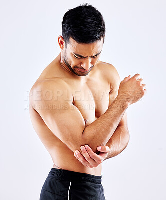 Buy stock photo Muscular man, elbow and bone with injury or pain from accident or fall on a white studio background. Frustrated male person or bodybuilder with sore arm, muscle or joint from tension or inflammation