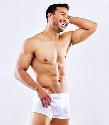 Buy stock photo Muscle, man and happy in underwear on studio, white background or bodybuilder mockup. Healthy, athlete and model with abs or training from fitness, exercise and progress from workout at gym aesthetic