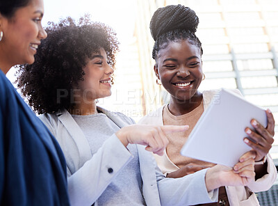 Buy stock photo Shot of a diverse group of businesswomen standing outside on the balcony and using a digital tablet