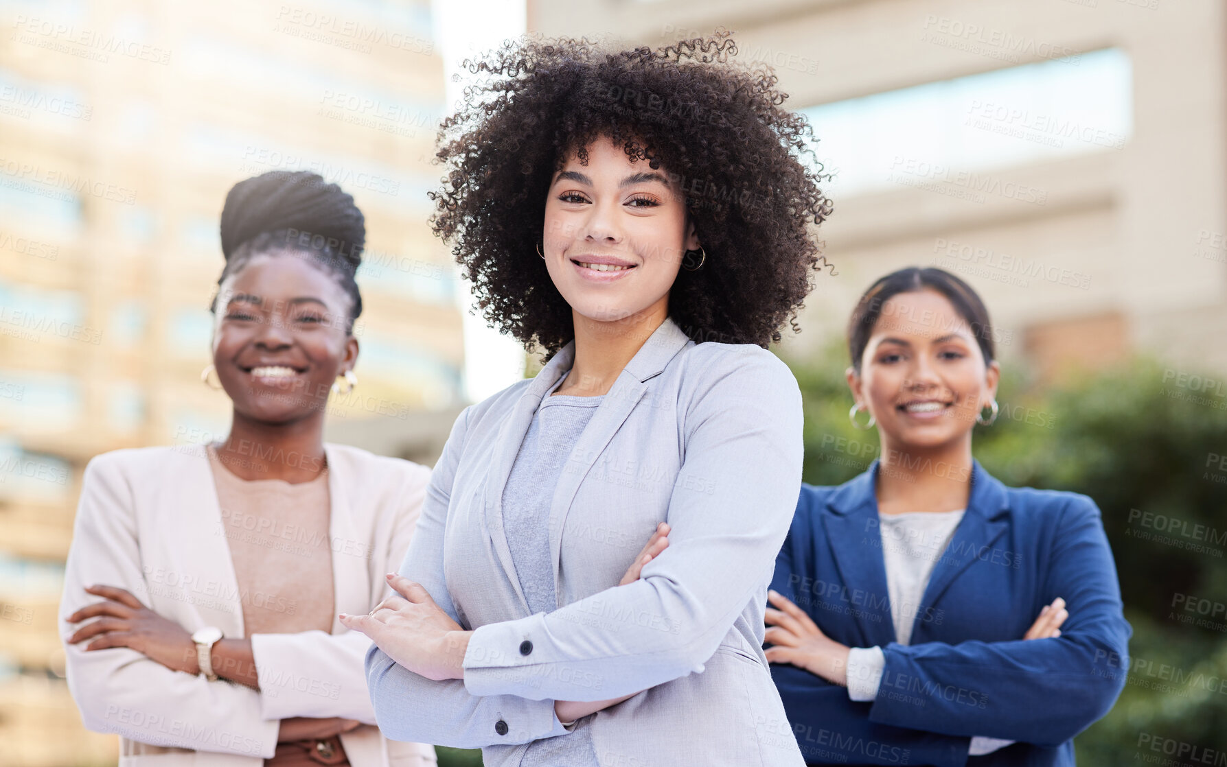 Buy stock photo Shot of a diverse group of businesswomen standing outside on the balcony with their arms folded