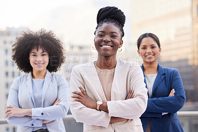 Buy stock photo Shot of a diverse group of businesswomen standing outside on the balcony with their arms folded