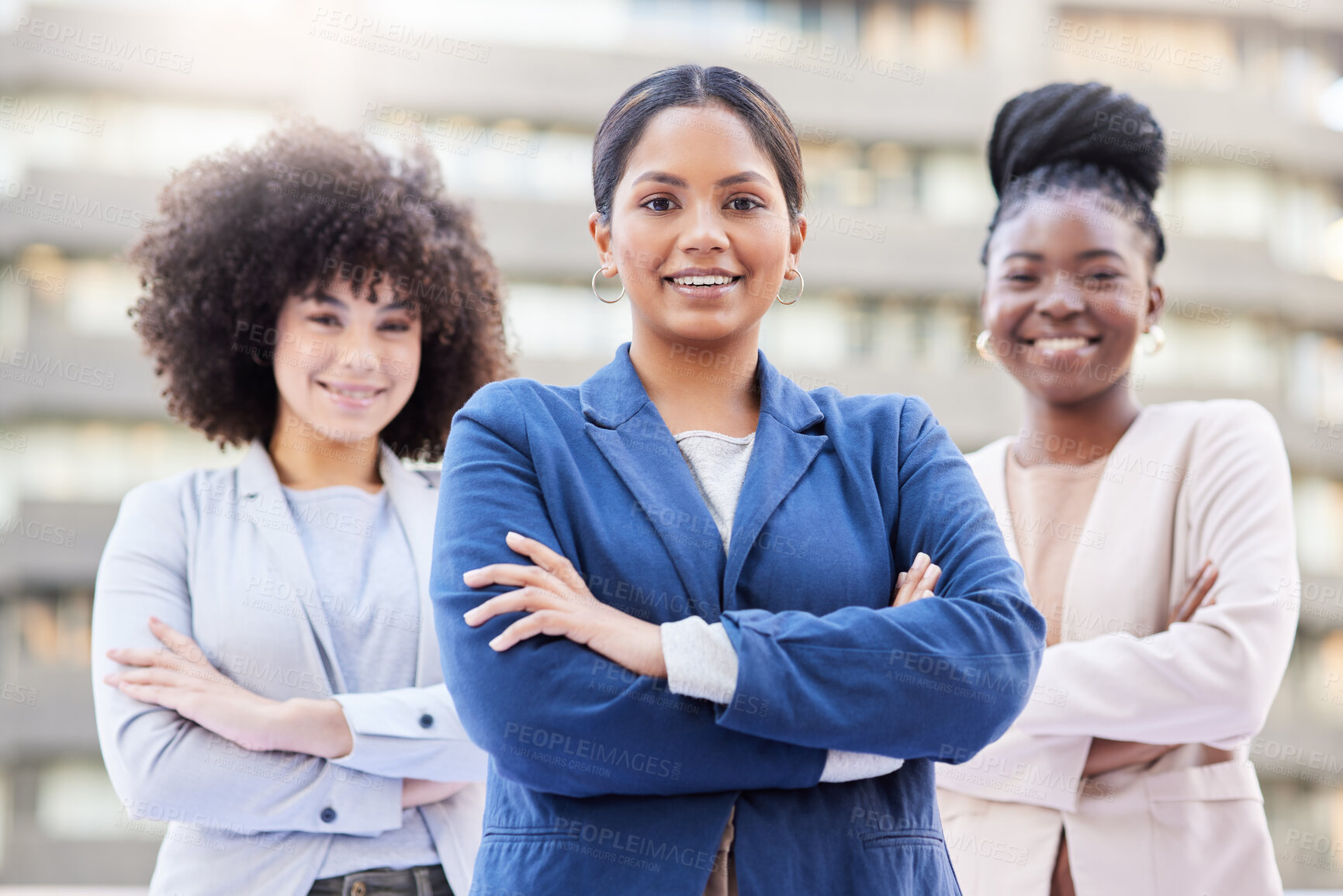 Buy stock photo Shot of a diverse group of businesswomen standing outside on the balcony with their arms folded