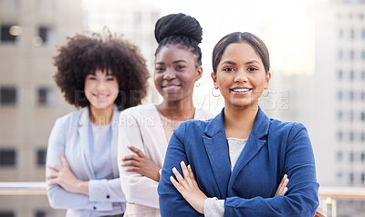 Buy stock photo Shot of a diverse group of businesswomen standing outside on the balcony with their arms folded