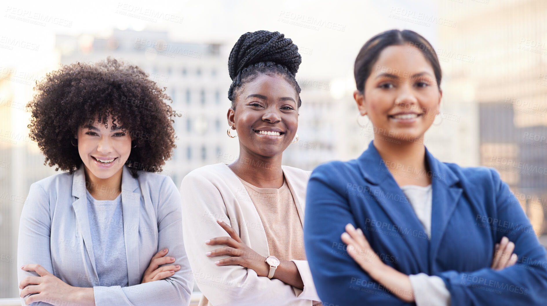 Buy stock photo Shot of a diverse group of businesswomen standing outside on the balcony with their arms folded