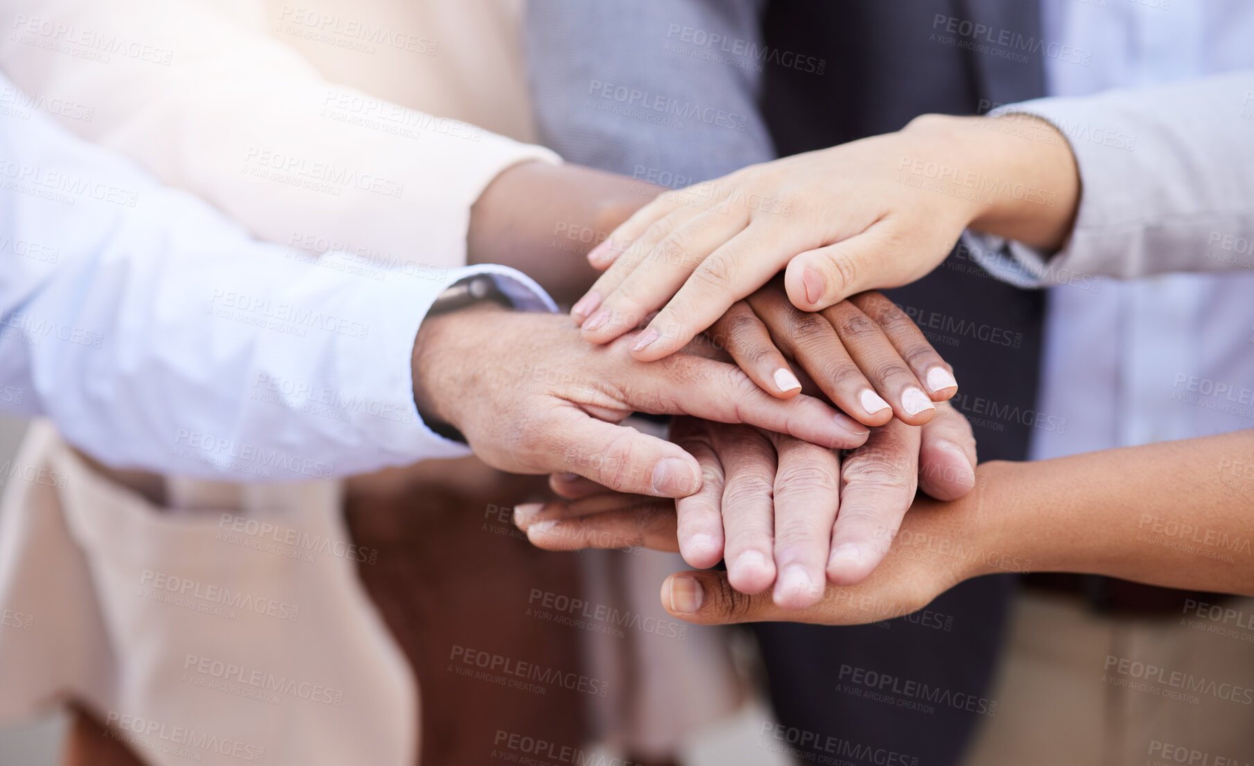 Buy stock photo Cropped shot of an unrecognisable group of businesspeople standing huddled together with their hands piled in the middle