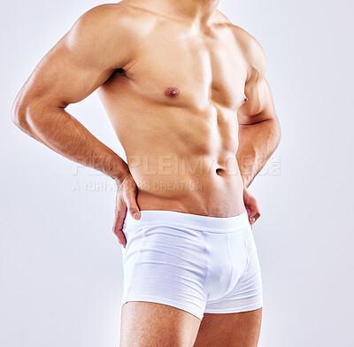 Buy stock photo Chest, muscle and bodybuilder in underwear on studio, white background or mockup of abdomen. Healthy, athlete and stomach of man with abs from fitness with exercise and workout at gym aesthetic