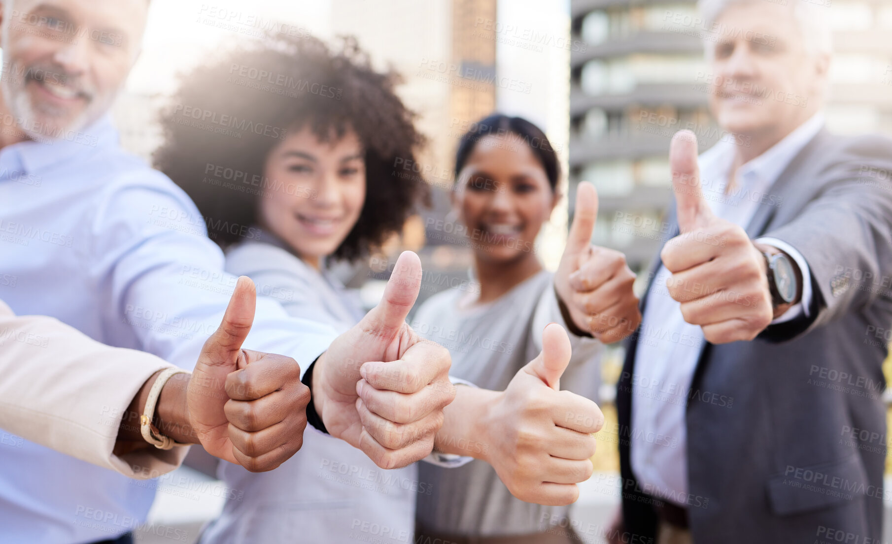 Buy stock photo Shot of a diverse group of businesspeople standing outside on the balcony together and showing a thumbs up