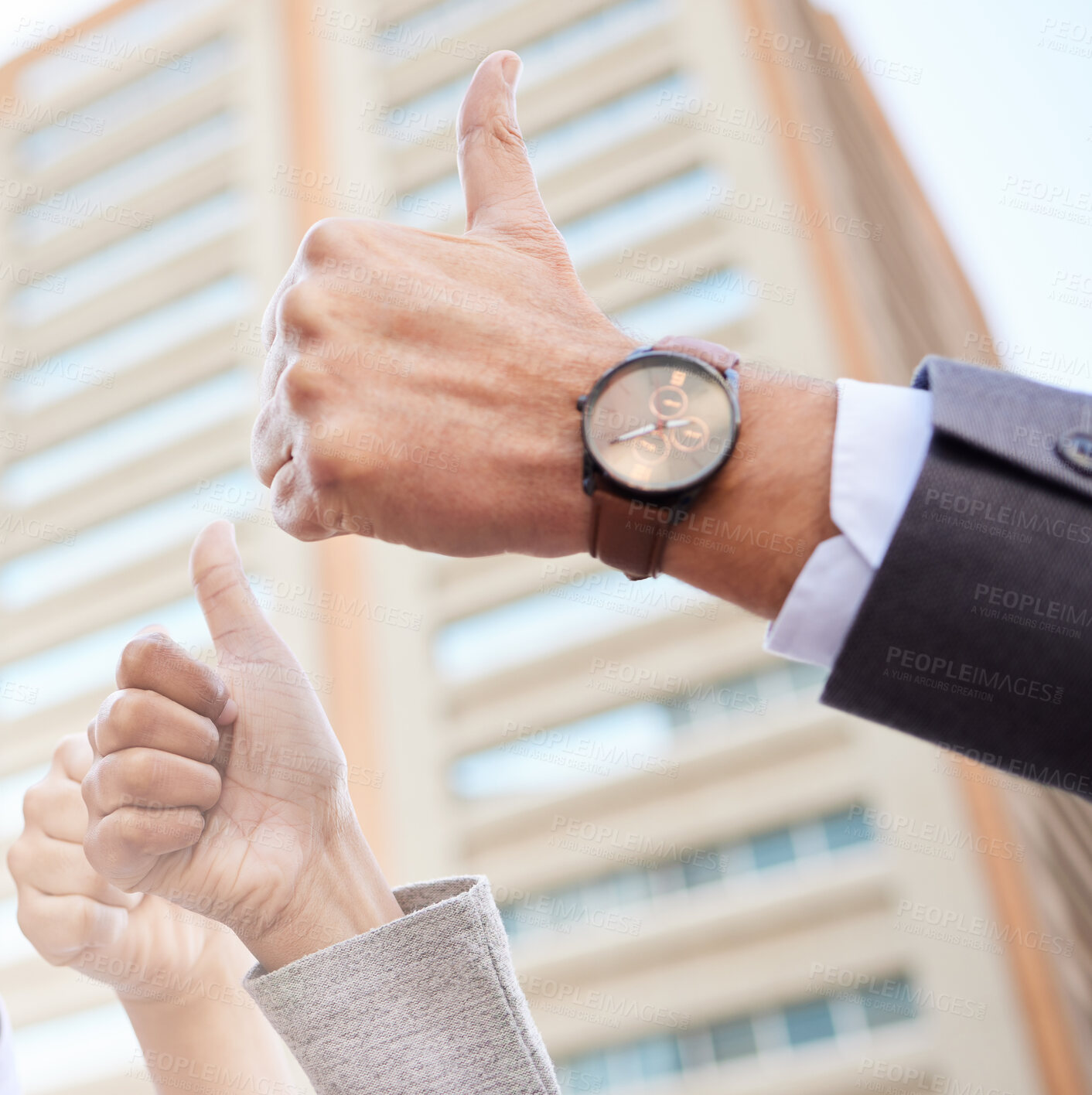 Buy stock photo Cropped shot of an unrecognisable group of businesspeople standing together outside and showing a thumbs up