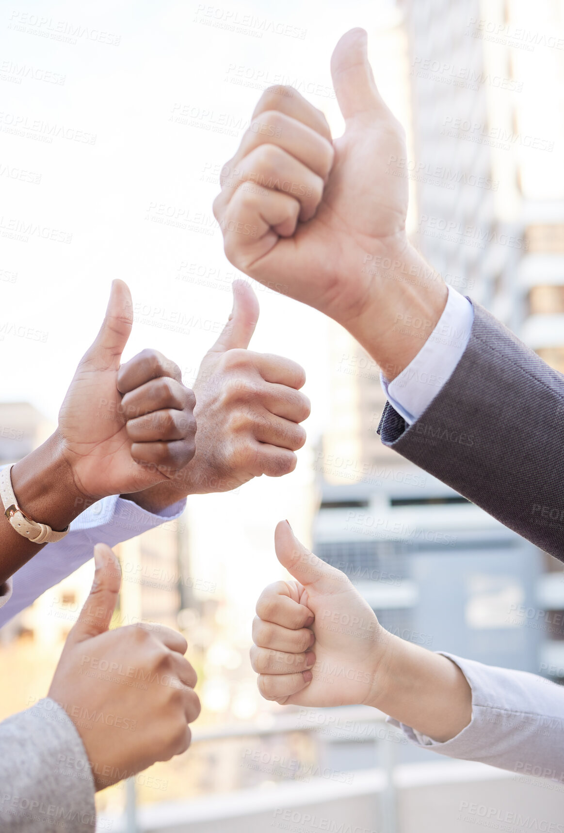 Buy stock photo Cropped shot of an unrecognisable group of businesspeople standing together outside and showing a thumbs up