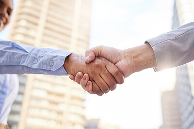 Buy stock photo Cropped shot of two unrecognisable businesspeople standing outside on the balcony together and shaking hands