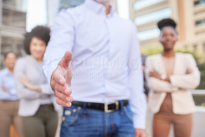 Buy stock photo Cropped shot of an unrecognisable businessman standing with his hand outstretched for a handshake while his colleagues stand behind him