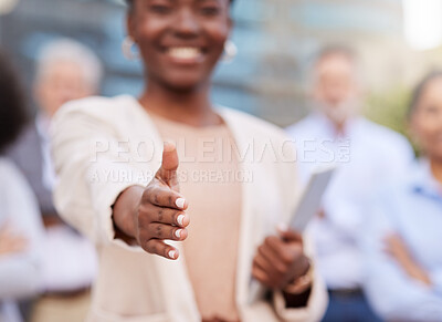 Buy stock photo Cropped shot of an unrecognisable businesswoman standing with her hand outstretched for a handshake while her colleagues stand behind her