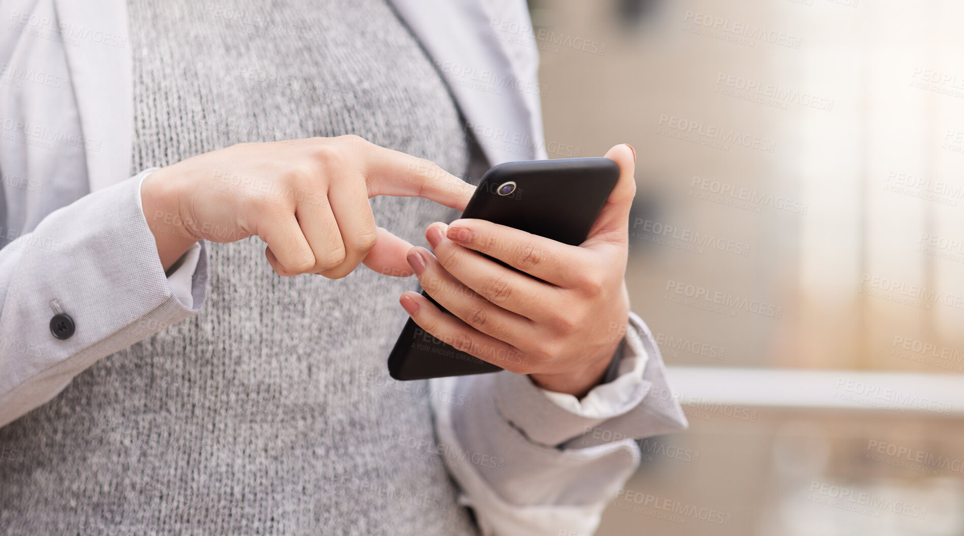 Buy stock photo Cropped shot of an unrecognisable businesswoman standing alone on the balcony outside and using her cellphone