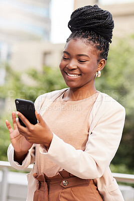 Buy stock photo Shot of an attractive young businesswoman standing alone on the balcony outside and using her cellphone