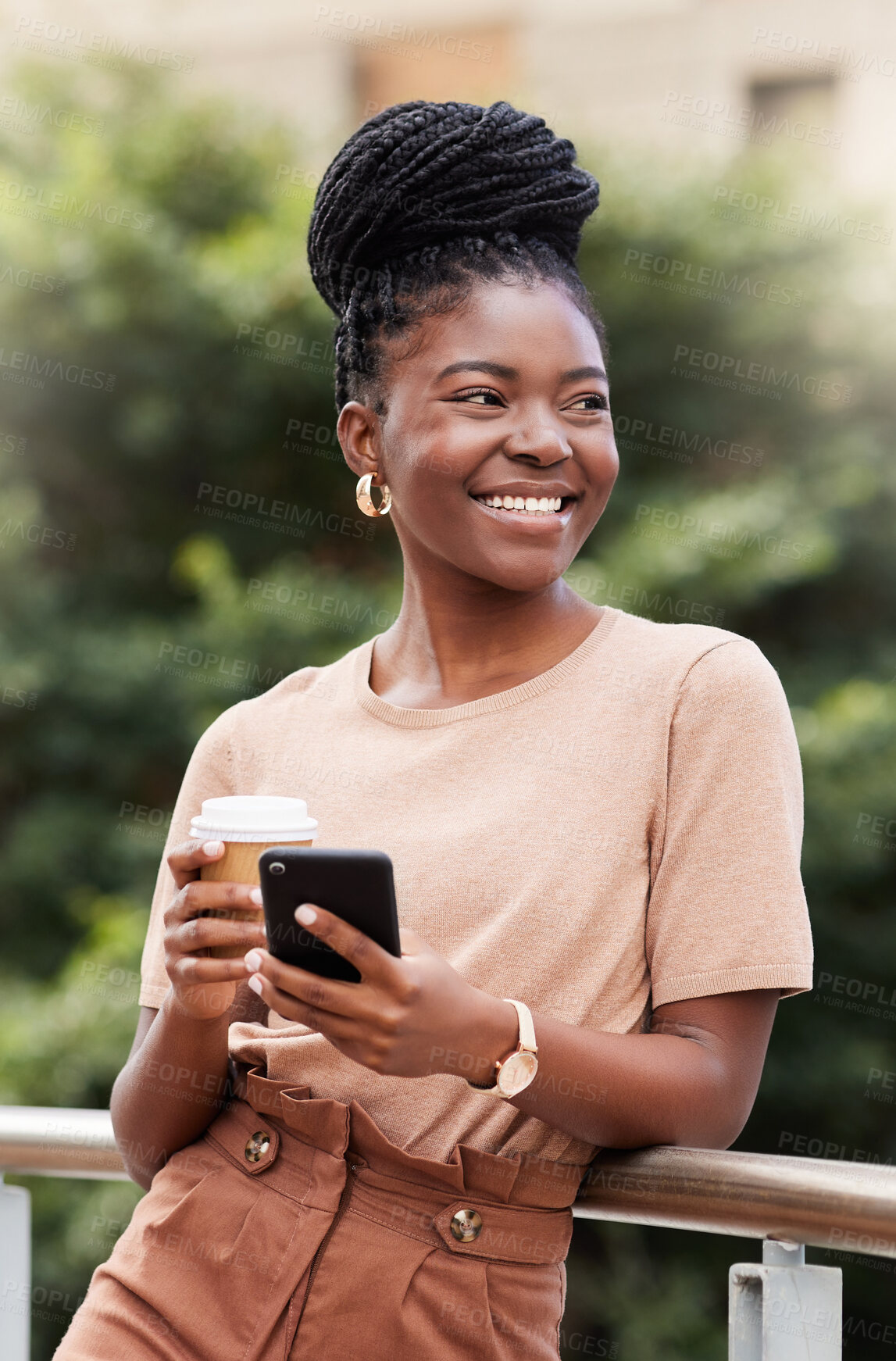 Buy stock photo Shot of a young businesswoman standing on the balcony outside and using her cellphone while holding a cup of coffee