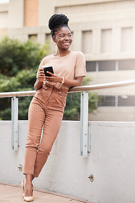 Buy stock photo Full length shot of a young businesswoman standing outside and using her cellphone while holding a cup of coffee