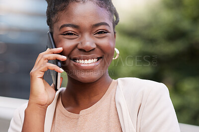 Buy stock photo Shot of an attractive young businesswoman standing alone on the balcony outside and using her cellphone