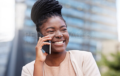 Buy stock photo Shot of an attractive young businesswoman standing alone on the balcony outside and using her cellphone