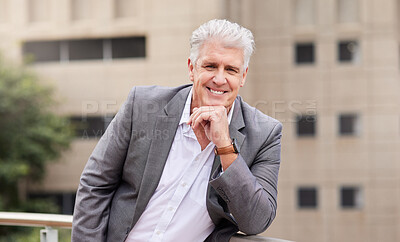 Buy stock photo Shot of a mature businessman standing alone outside on the balcony