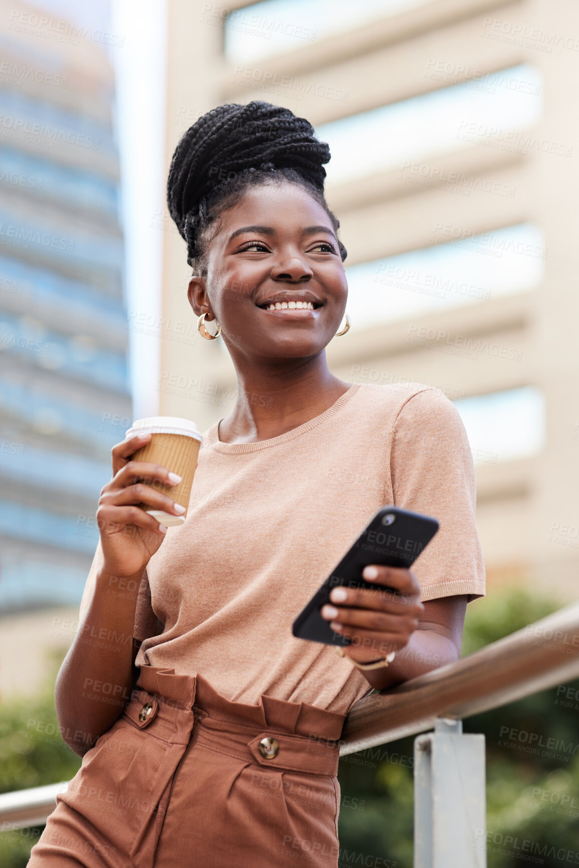 Buy stock photo Shot of a young businesswoman standing on the balcony outside and using her cellphone while holding a cup of coffee