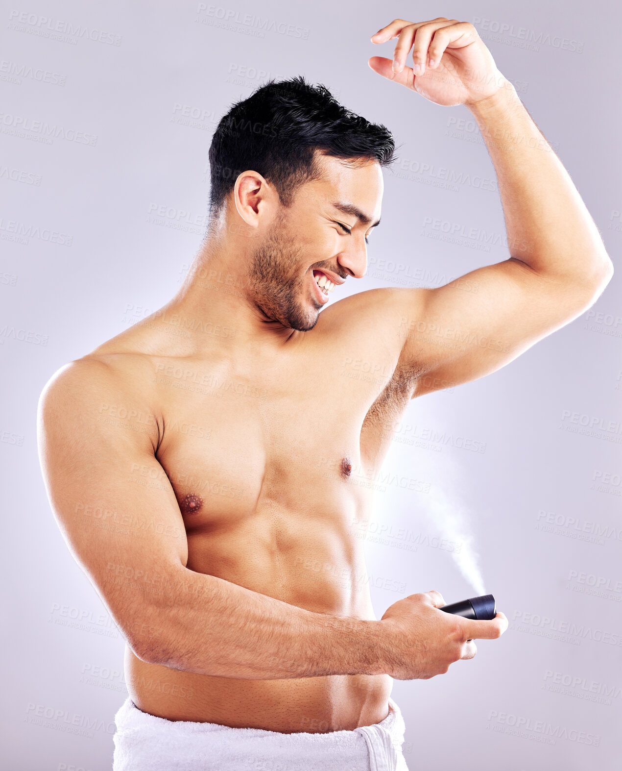 Buy stock photo Man, grooming and smile with deodorant in studio background for hygiene, cleanliness and wellness. Male person, happy and confident with spray for odor, fragrance and body freshness or health