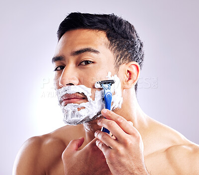 Buy stock photo Portrait, man and shaving with razor in studio for cleaning, health or hair removal for hygiene isolated on white background. Cream, face and model cut beard for skincare, grooming or beauty