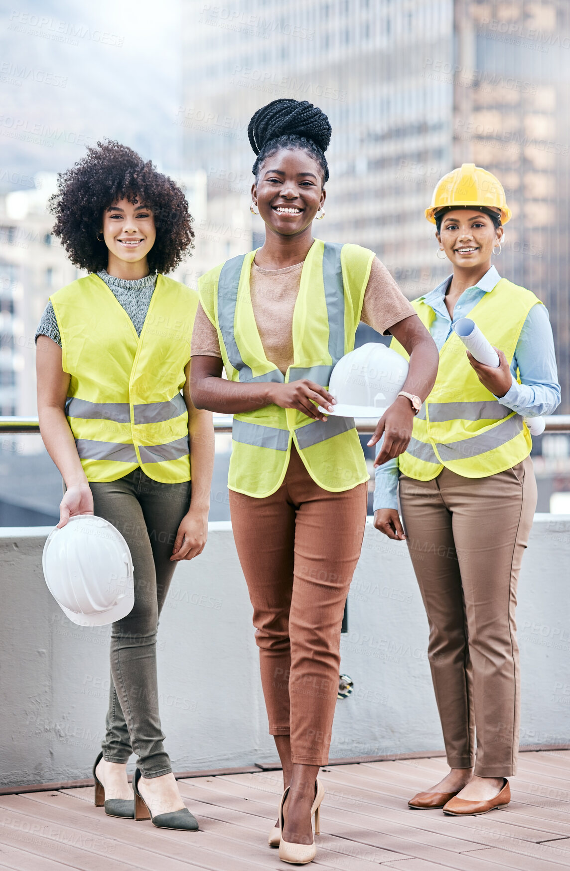 Buy stock photo Portrait of a group of confident young businesswomen working at a construction site