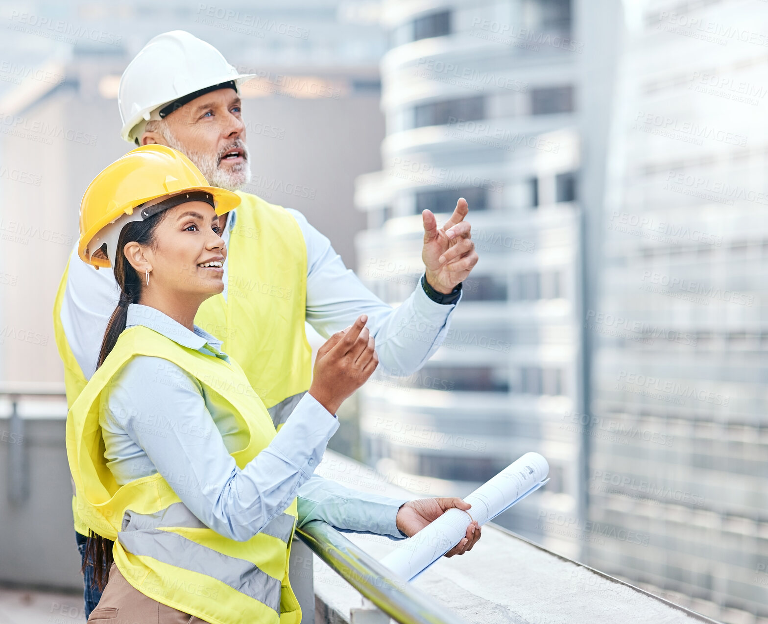 Buy stock photo Shot of two businesspeople working together at a construction site