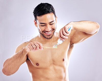 Buy stock photo Man, smile with toothpaste and studio background for dental hygiene, cleanliness and wellness. Male person, happy or confident with toothbrush for mouth odor, freshness and healthcare or whitening