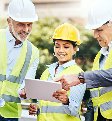Buy stock photo Shot of a group of businesspeople using a digital tablet while working at a construction site