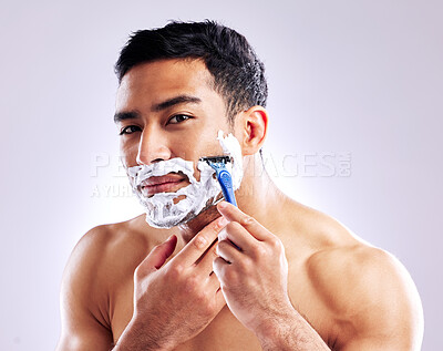 Buy stock photo Portrait, man and shaving with razor for skincare, health or hair removal for hygiene isolated on white studio background. Cream, face or model cut beard for cleaning, grooming or beauty for wellness