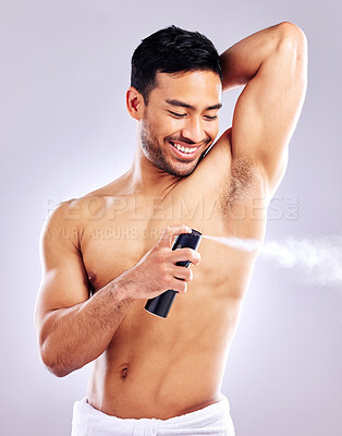 Buy stock photo Man, grooming armpit and smile with deodorant in studio background for hygiene, cleanliness and wellness. Male person, happy and confident with body spray for odor, fragrance and fresh scent