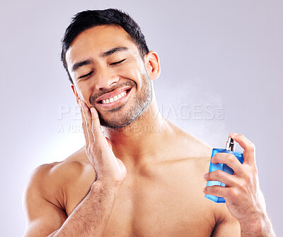Buy stock photo Man, smile and aftershave for spray, grooming or beard for beauty and aesthetic wellness for healthy skin on studio background. Happy, guy and model for facial hair or dermatology, body and cosmetics