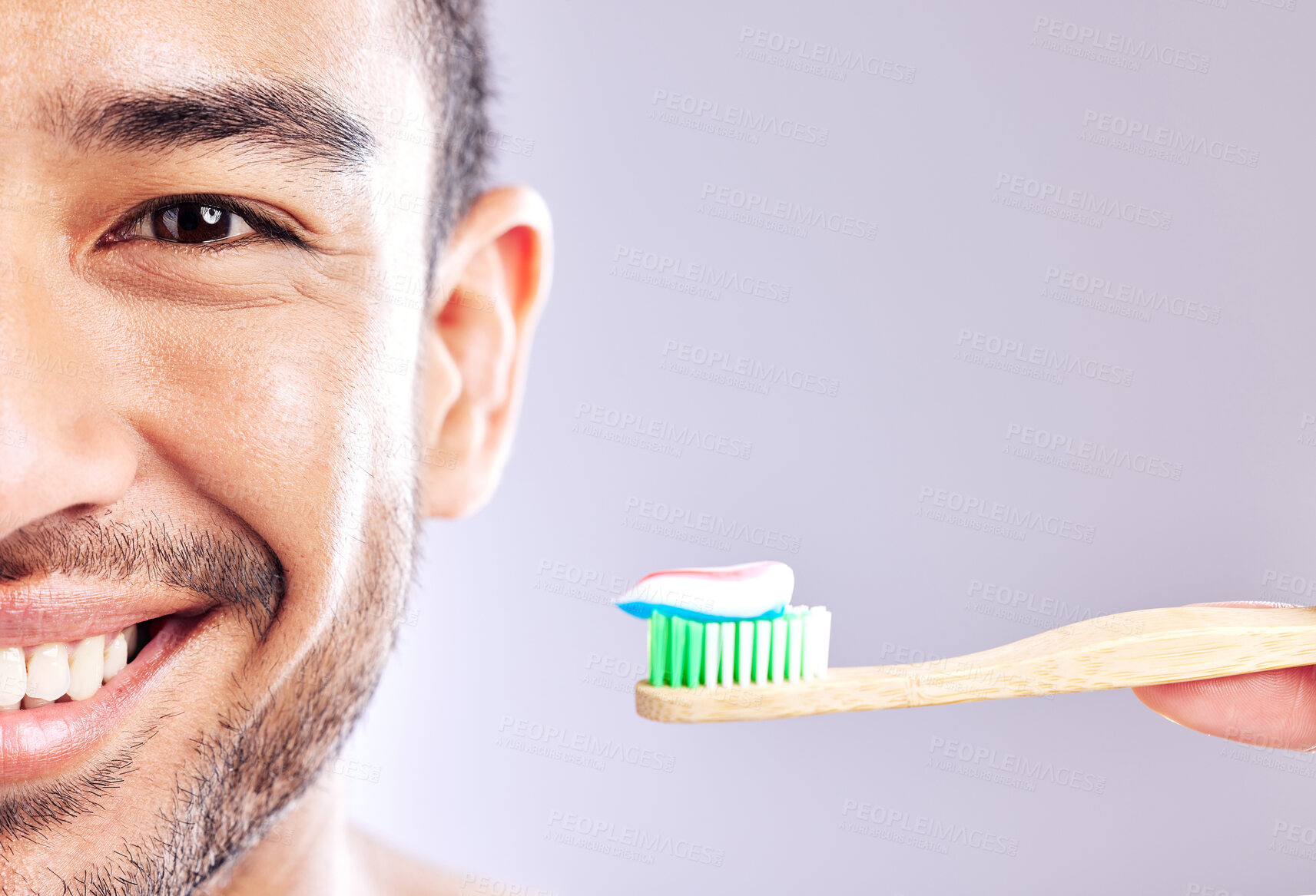 Buy stock photo Studio shot of a handsome young man holding up his toothbrush