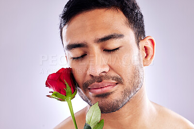 Buy stock photo Man, rose and closeup in studio for natural skincare, organic ingredients and cosmetics. Model, flower and floral on white background with mockup space for makeup, facial cleanser and dermatology