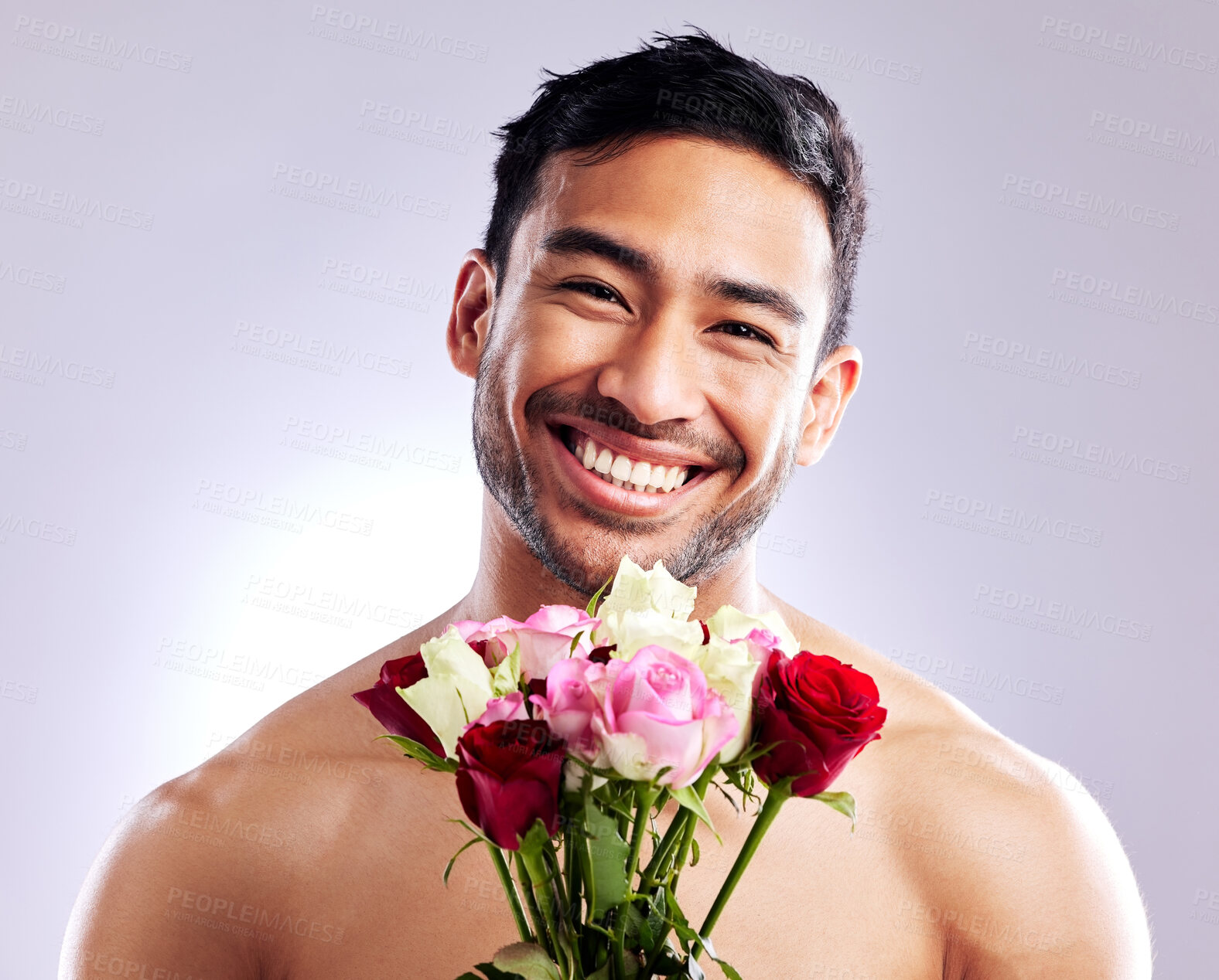 Buy stock photo Man, portrait and shirtless with rose in studio for natural scent, luxury fragrance and cosmetics. Spanish model, flowers and naked on background with mockup space for organic or designer cologne