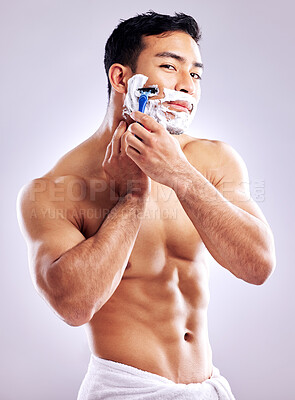 Buy stock photo Cropped shot of a handsome young man shaving his facial hair