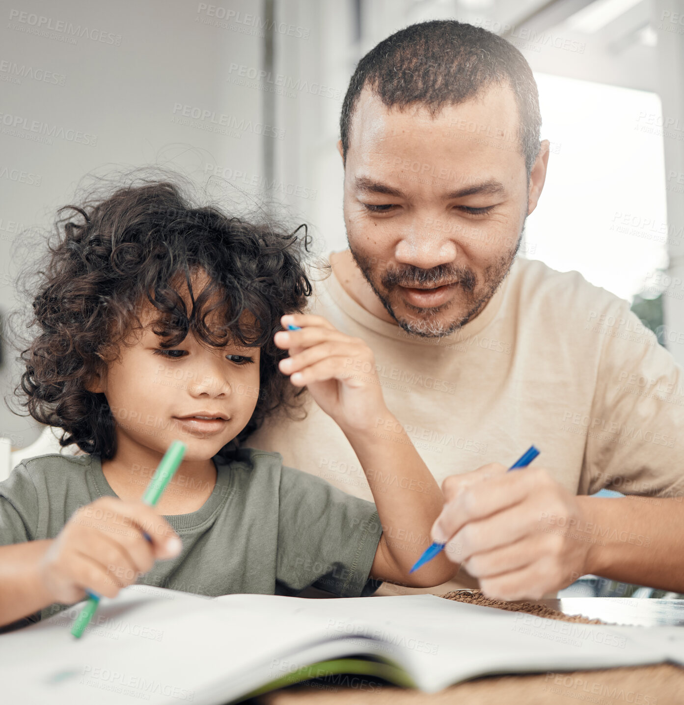 Buy stock photo Shot of a man helping his son with his homework