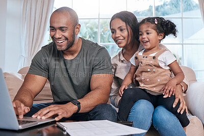 Buy stock photo Shot of a couple and their little daughter using a laptop at home