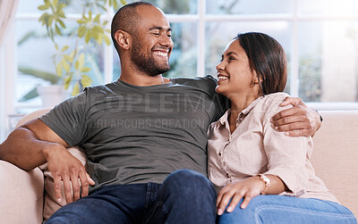 Buy stock photo Shot of a happy young couple relaxing together at home