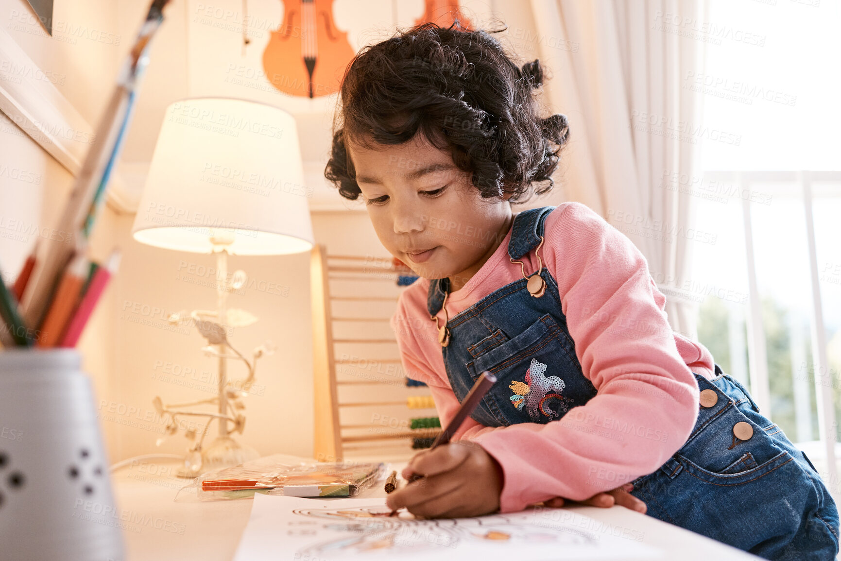 Buy stock photo Shot of a little girl drawing on a piece of paper at home