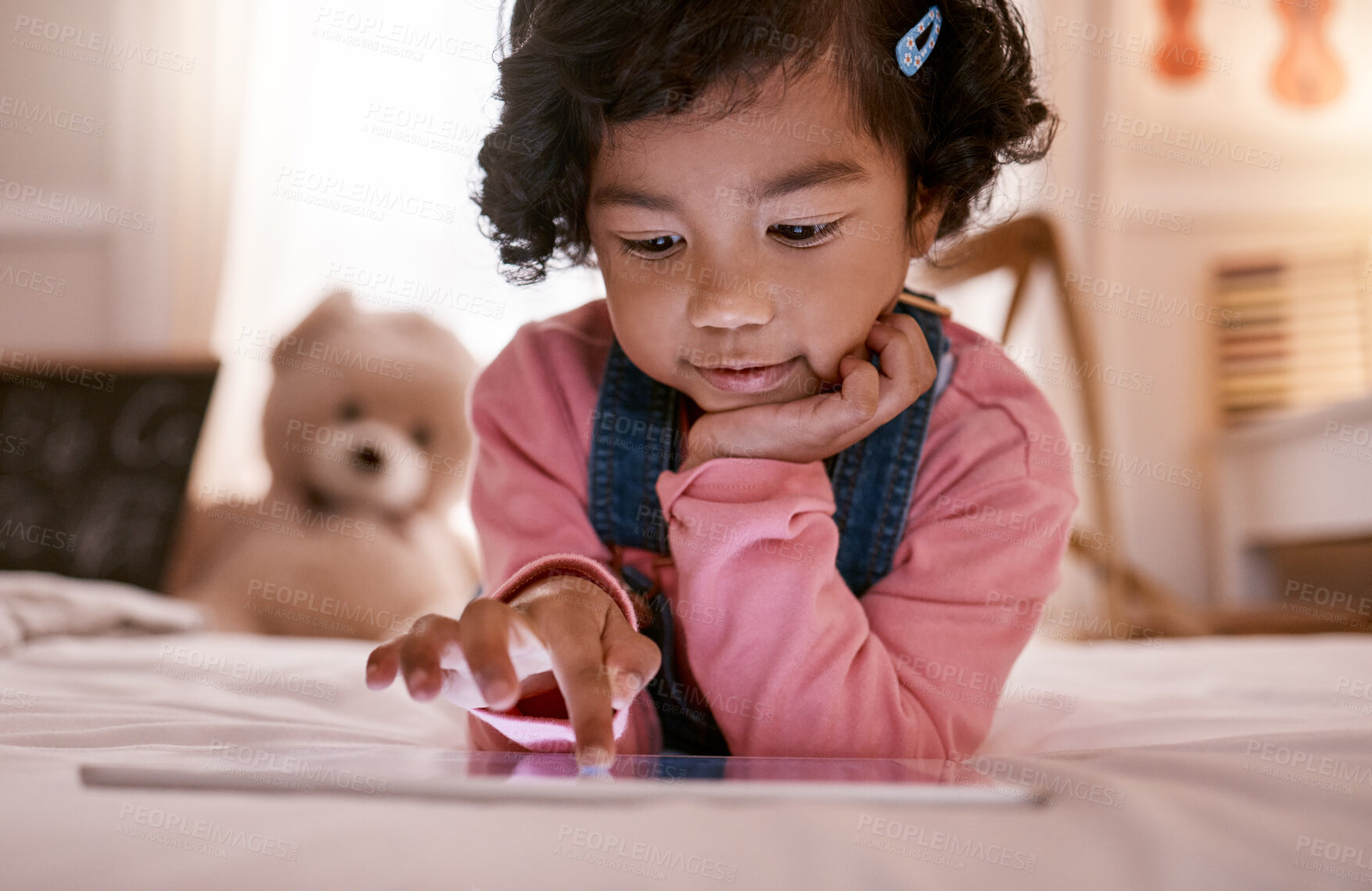 Buy stock photo Shot of a little girl using a digital tablet at home