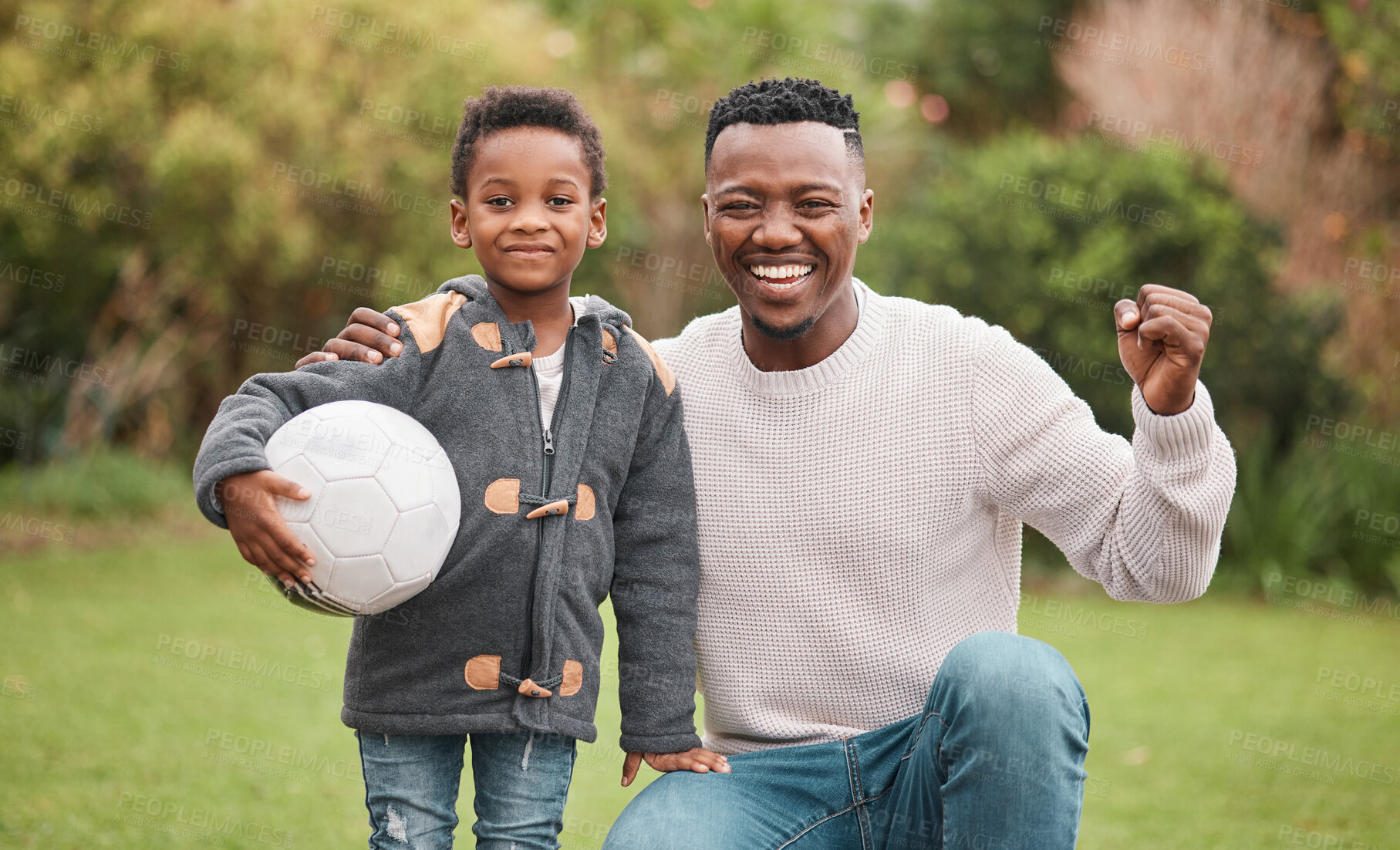 Buy stock photo Portrait of a father and his son playing with a soccer ball together outdoors