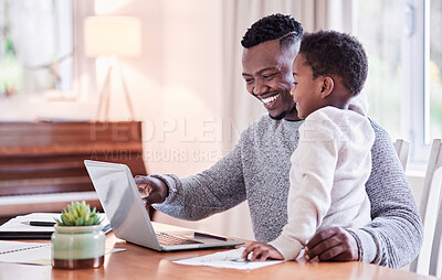 Buy stock photo Shot of a young man working while caring for his adorable baby girl at home